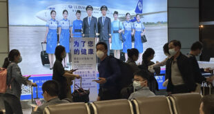 Passengers prepare to board a flight at the airport in north-central China's Jiangxi province on Nov. 1, 2022. The Chinese…