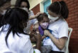 Four-year-old Clarice Moretti is held by her mother as she a dose of the CoronaVac vaccine at a vaccination center in Rio de…