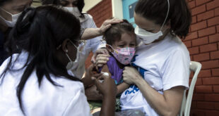 Four-year-old Clarice Moretti is held by her mother as she a dose of the CoronaVac vaccine at a vaccination center in Rio de…